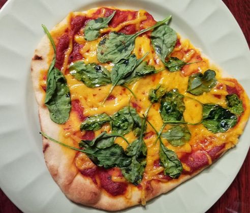 spinach and vegan cheese pizza